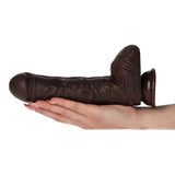 Dildo realistico marrone scuro 25 cm su palma, testa sferica e venature visibili