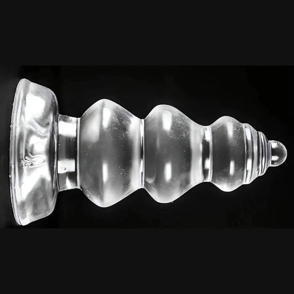 Plug anale trasparente Chikubi a gradini con ventosa base su sfondo nero