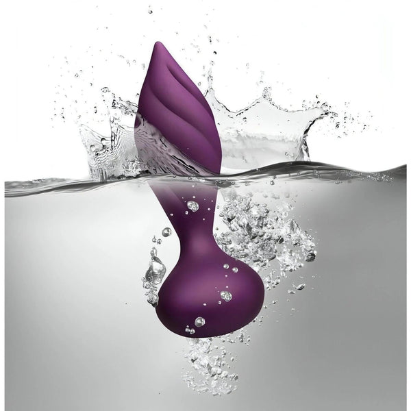 Plug anale Desire viola impermeabile a spirale immerso nell'acqua con spruzzi