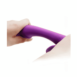 Vibratore rabbit viola in silicone usato su pelle con asta curva flessibile