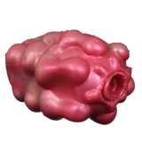 Masturbatore Jagged Bones rosa in silicone liquido con forma organica e apertura ondulata