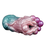 Toy in silicone liquido bicolore turchese e rosa con dettagli tentacoli, texture floreale e sfere viola