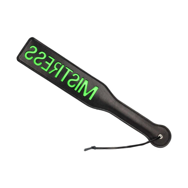 Paletta spanking nera con logo MISTRESS verde neon su sfondo bianco