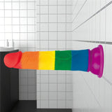 Dildo arcobaleno in silicone medicale posizionato su sfondo da bagno
