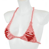 Reggiseno giocattolo in caramelle a forma di dischetto rosa su manichino bianco