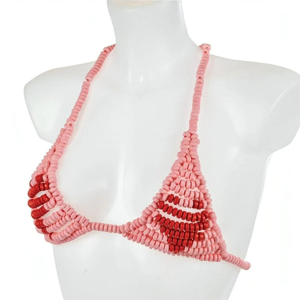 Reggiseno giocattolo in caramelle a forma di dischetto rosa su manichino bianco