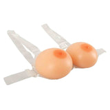 Protesi seno silicone colore pelle su supporto con cinghie da angolazione laterale