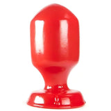 Plug anale rosso lucido forma cuneo vista frontale centrata