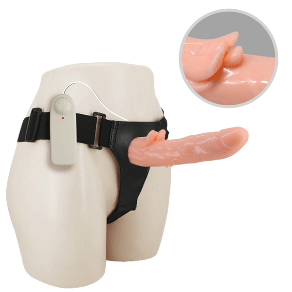 Dettaglio testa realistica dildo rosa con texture anatomica su strap-on