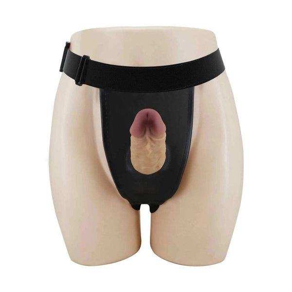 Strapon vuoto nero indossato su manichino con pene in silicone inserito verticalmente