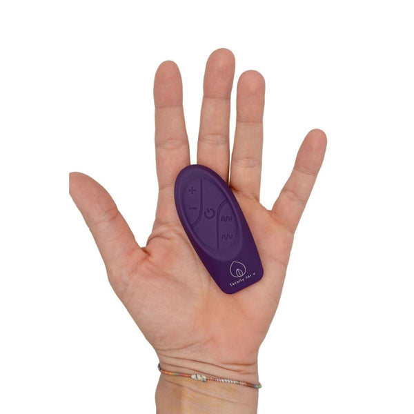Mano che tiene telecomando wireless Venere viola Totally for u con simboli controllo