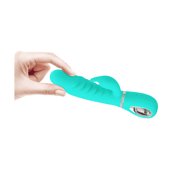 Vibratore rabbit turchese tenuto in mano con controlli a simboli