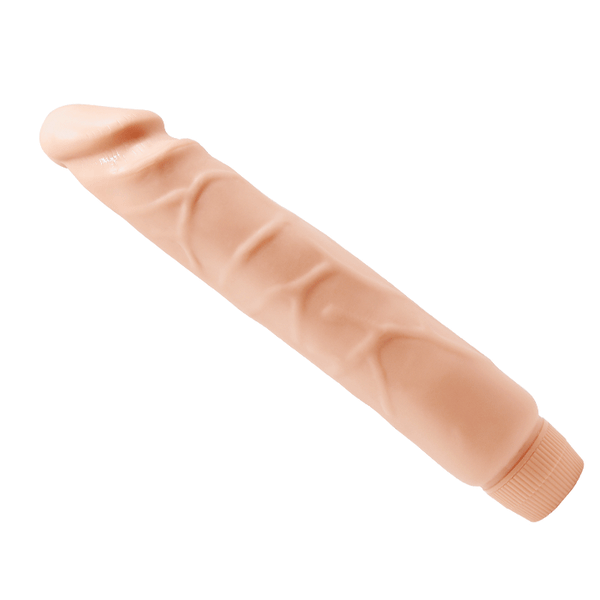 Dildo vibrante Soft Skin rosa carne vista diagonale con finitura pelle naturale e base circolare