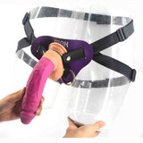 Strap-on rosa acceso con supporto viola e logo FNAK